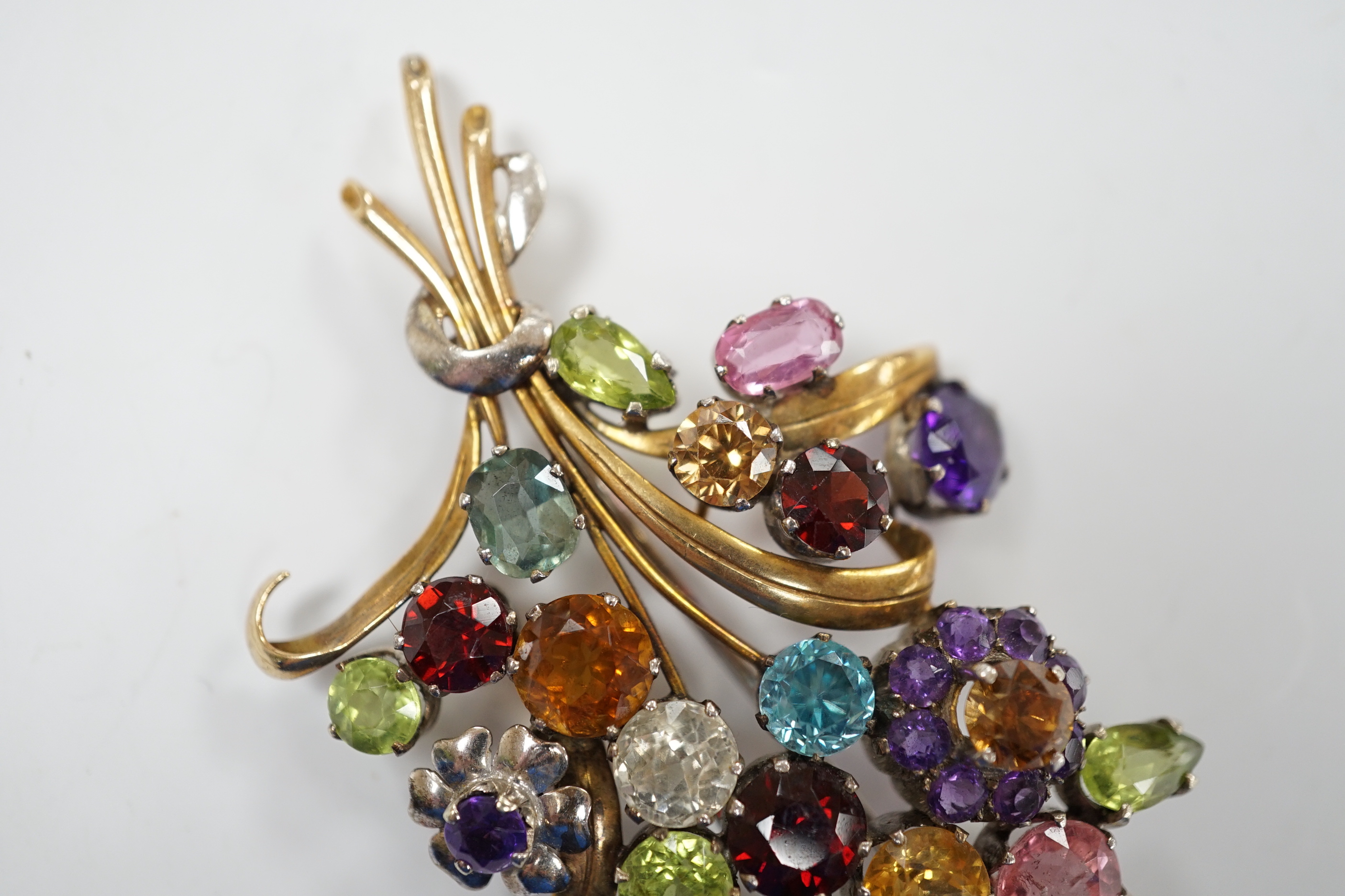 A 9ct and multi gem set floral spray brooch, including zircons, tourmaline and amethyst, by Cropp & Farr, 85mm gross weight 23.1 grams